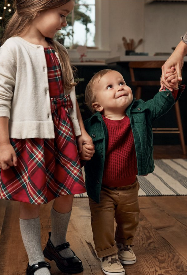 Little boy and girl in Christmas outfits