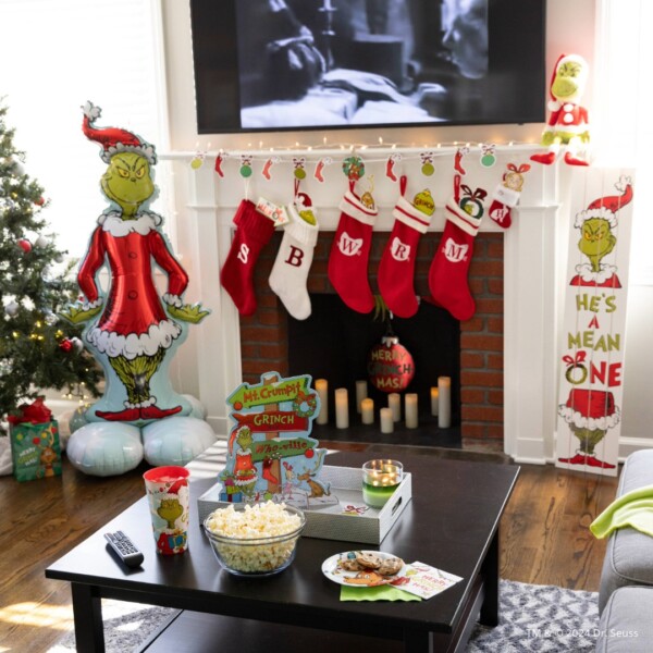 Christmas tree with Grinch inflatable and Grinch snacks on table