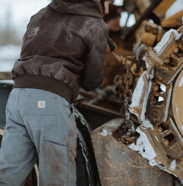 Man putting chains on equipment