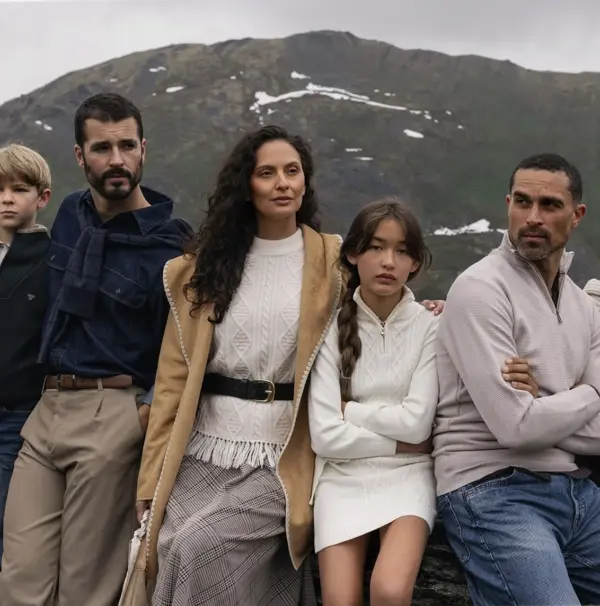 Group in fall clothes by mountain